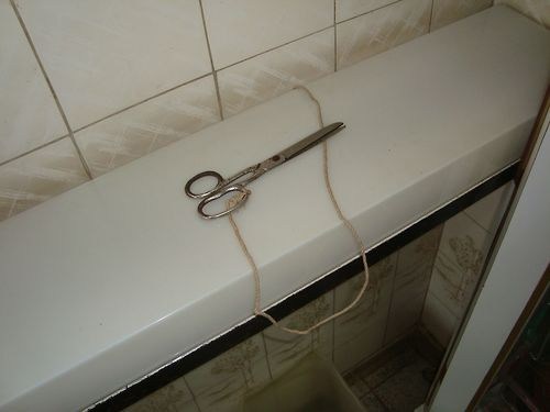 scissors protected with a string